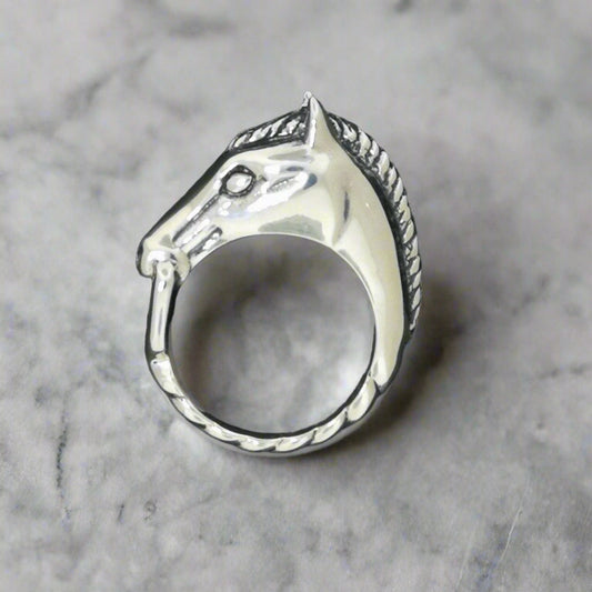 Closeup of handmade 3D horse head ring with bridle shown in sterling silver for equestrian jewelry lovers and Western style fans - Le Dragon Argenté