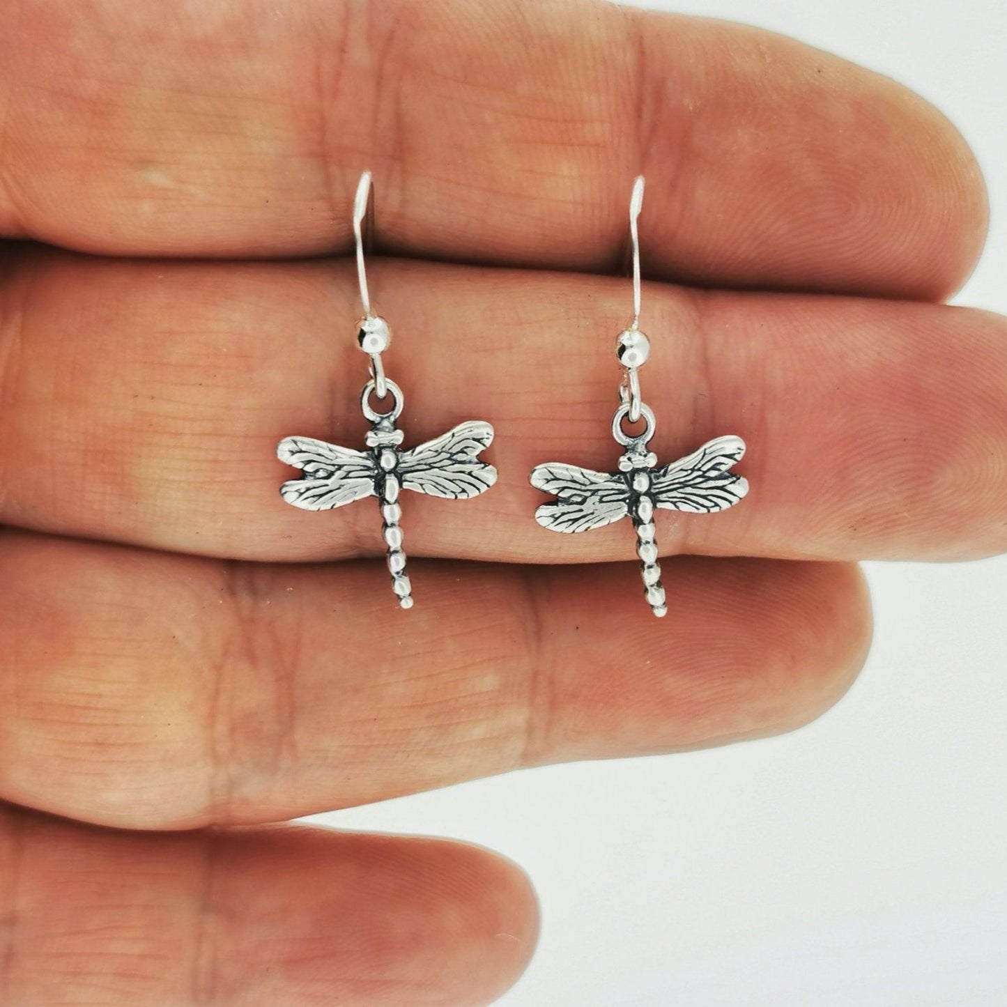 Dragonfly Charm Earrings in Sterling Silver in hand - Le Dragon Argenté