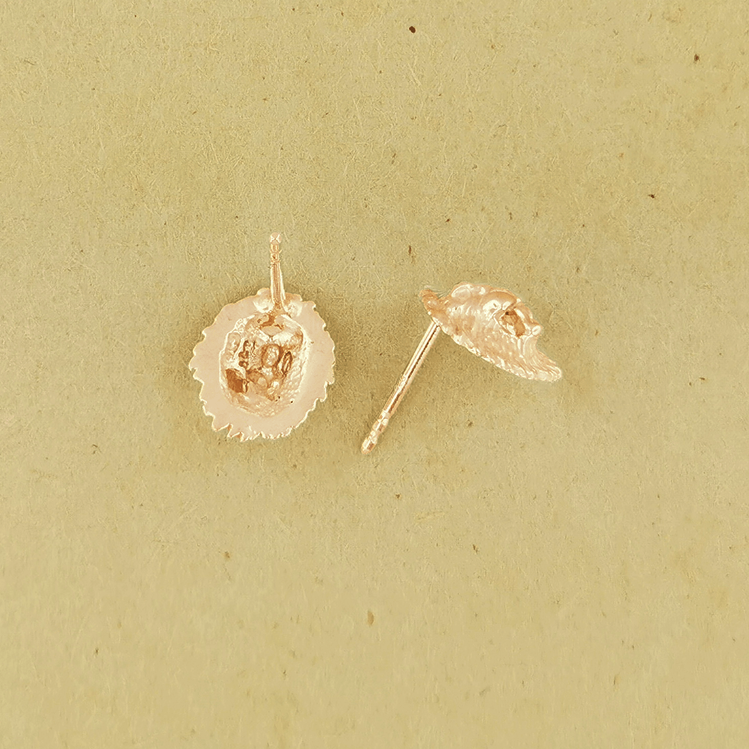 Made-to-order lion head studs by Le Dragon Argenté in solid gold, available in white, pink, or yellow gold and 10k, 14k, or 18k options.