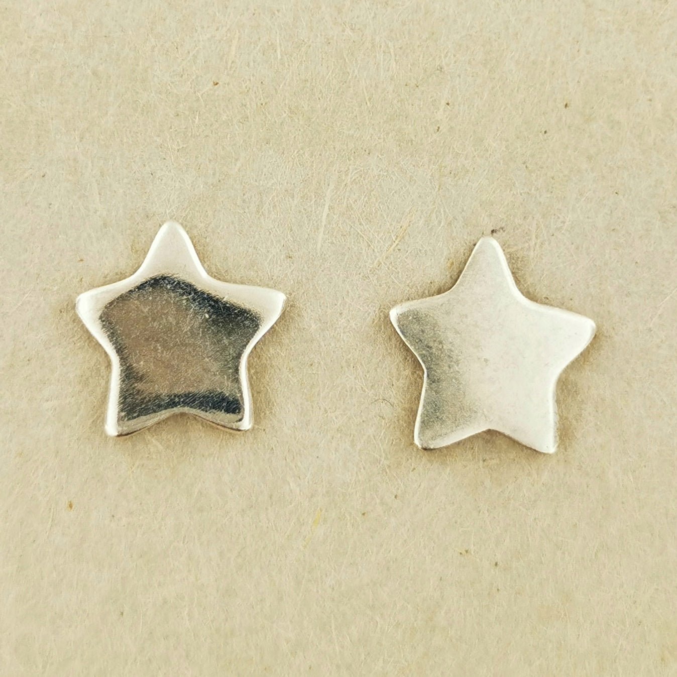 Handmade star-shaped stud earrings in sterling silver, celestial jewellery by Le Dragon Argenté