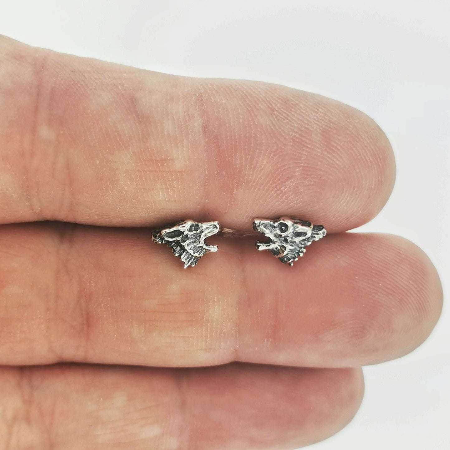 Howling wolf sterling silver earrings by Le Dragon Argenté, capturing wild spirit and natural strength in detailed handcrafted studs.