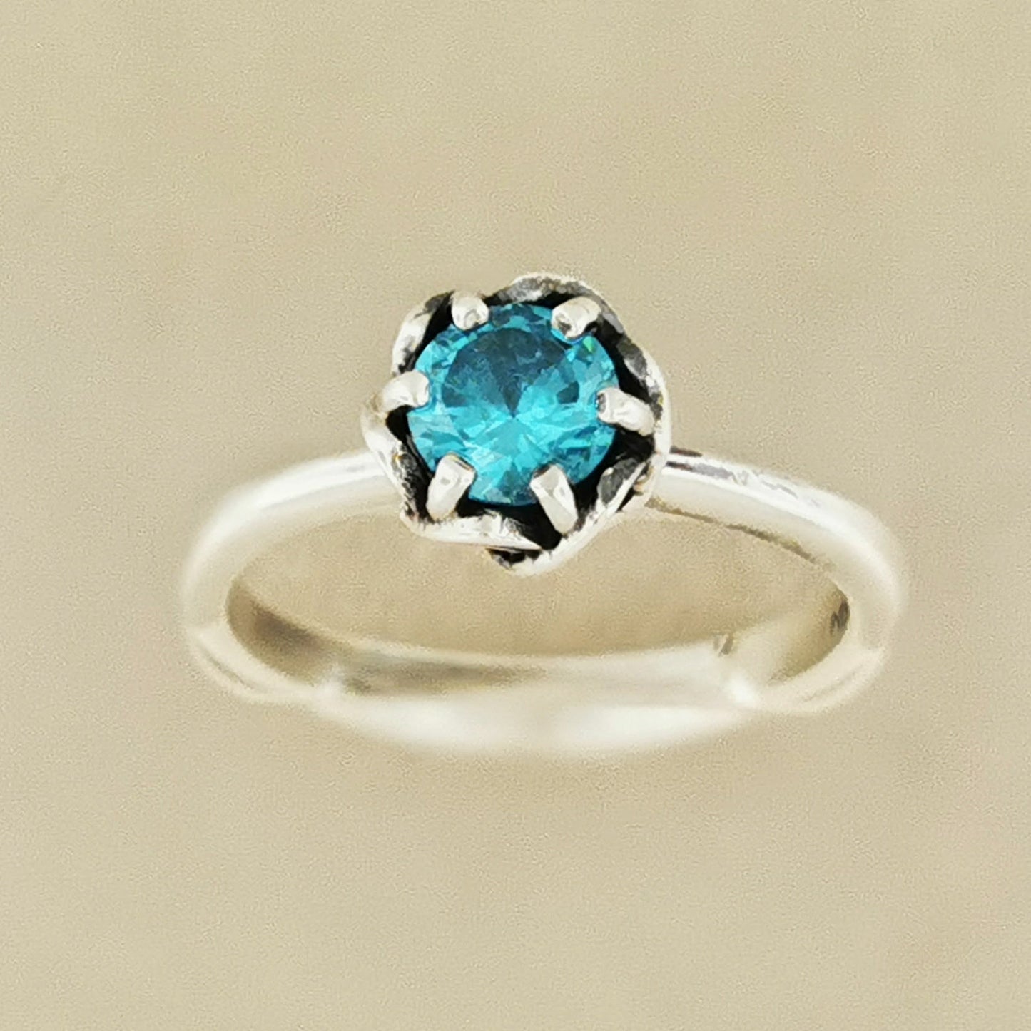 Handmade Solitaire Ring in .925 Sterling Silver with a 5mm coloured cubic zirconia birthstone set in a 6-prong solitaire style and delicate scrollwork design. Perfect gift or promise ring for her, elegant, timeless, and handcrafted by Le Dragon Argenté in Montreal, Canada.