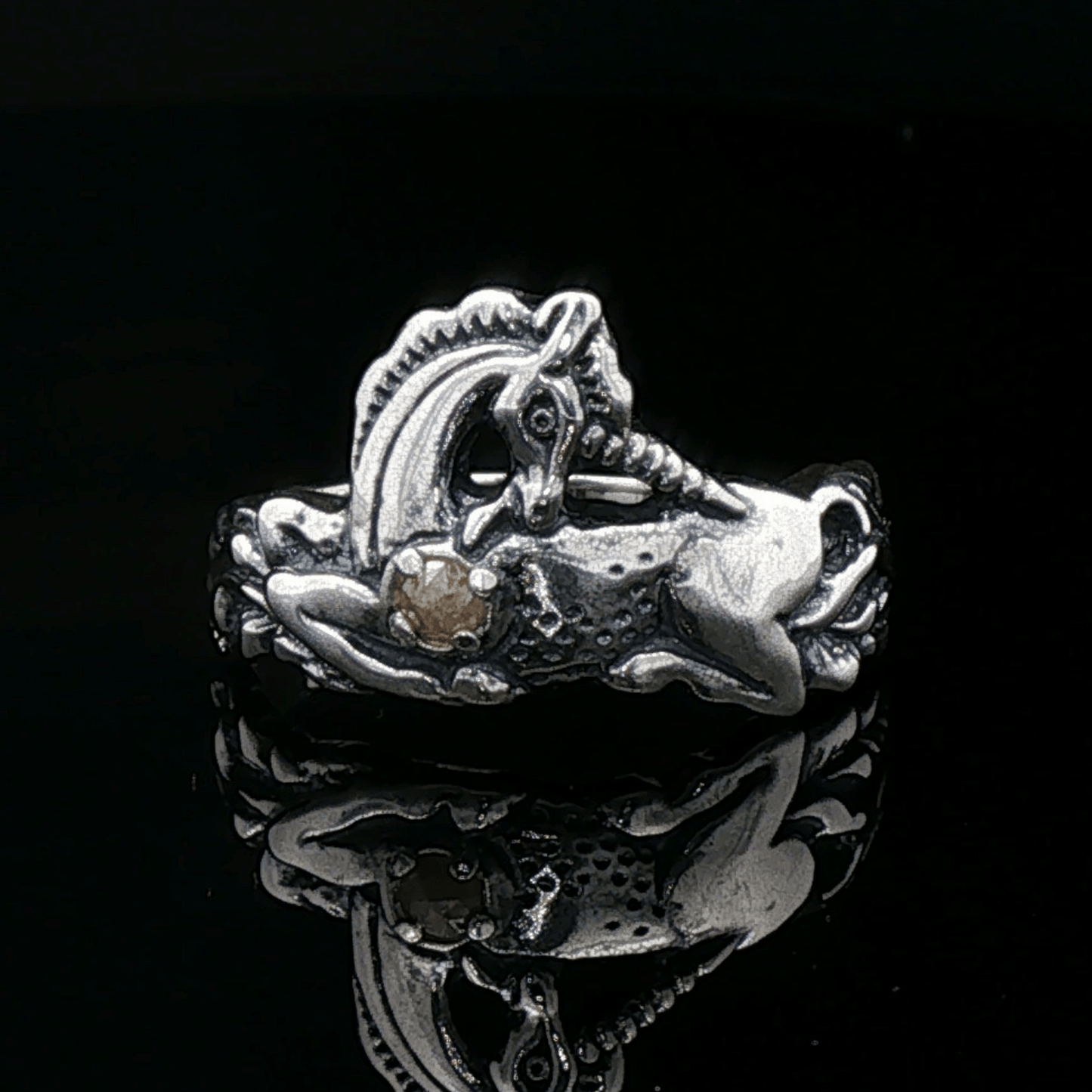A detailed sterling silver unicorn ring with a vibrant gemstone heart, designed for lovers of unicorn jewelry and fantasy-inspired accessories by Le Dragon Argenté.