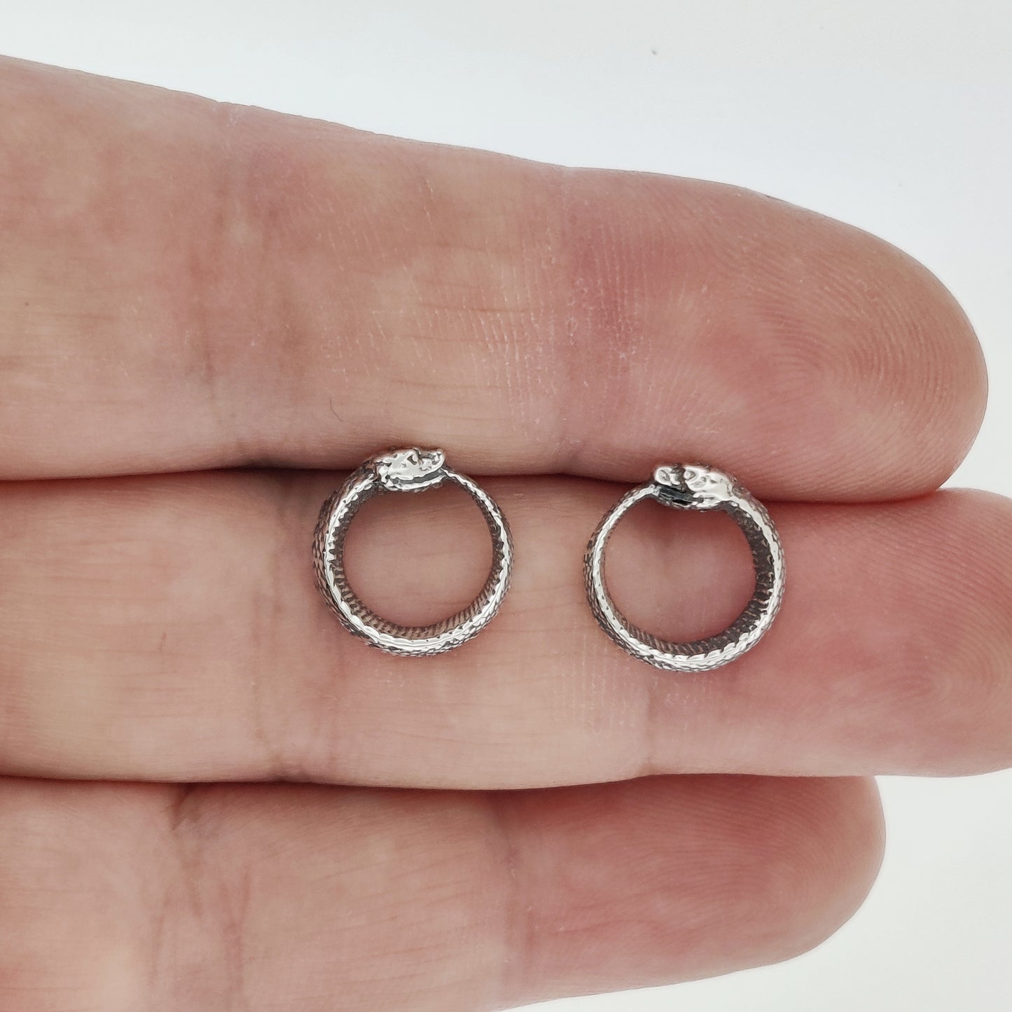 ouroboros stud earrings in sterling silver, silver ouroboros earrings, sterling silver ouroboros earrings, silver stud earrings, silver snake earrings, snake eating it's own tail, metaphysical earrings, pagan earrings in sterling silver, silver snake stud earrings, ouroboros stud earrings