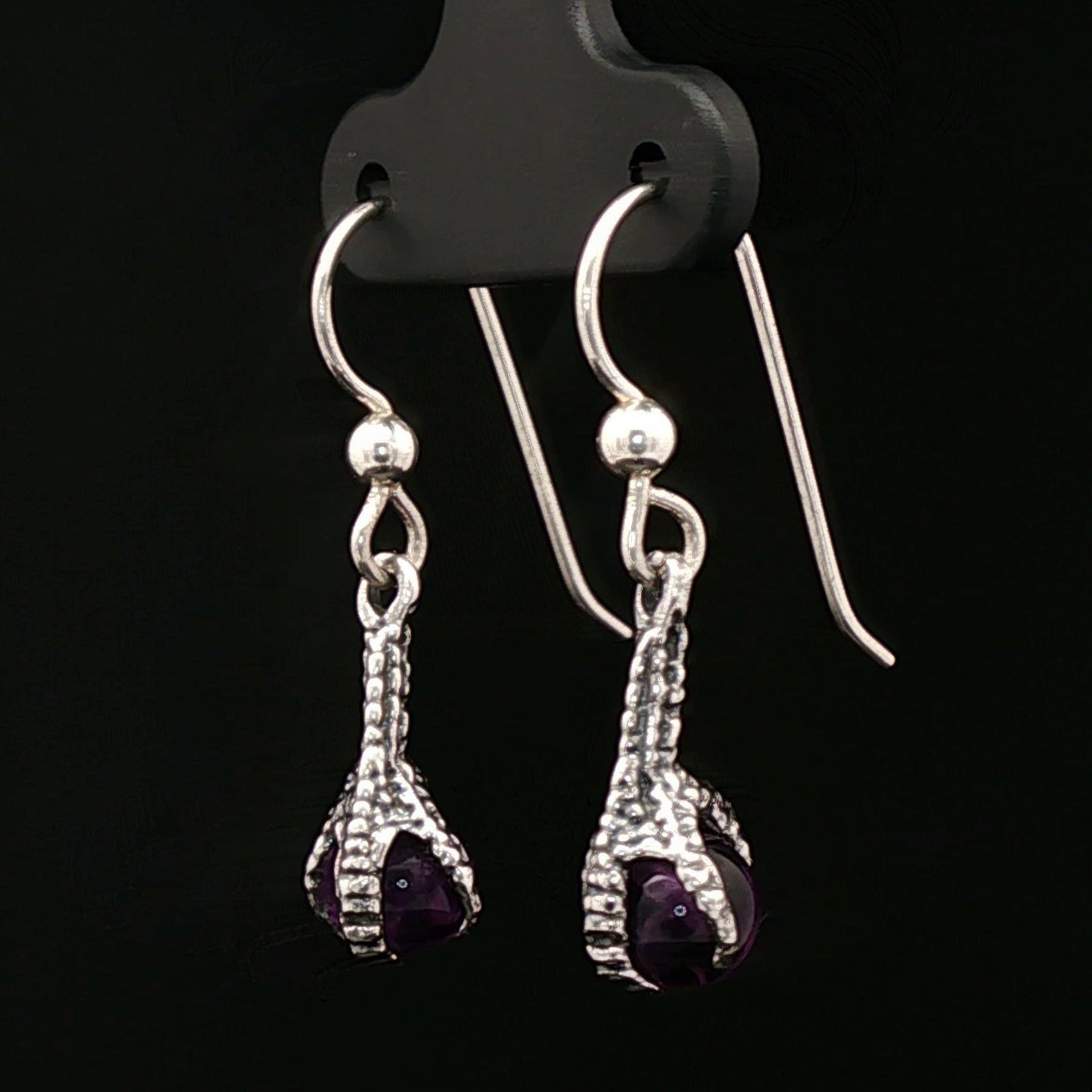 These sterling silver claw dangle earrings feature a gemstone bead and are part of the handmade fantasy jewellery collection by Le Dragon Argenté.