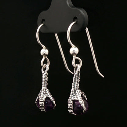 These sterling silver claw dangle earrings feature a gemstone bead and are part of the handmade fantasy jewellery collection by Le Dragon Argenté.