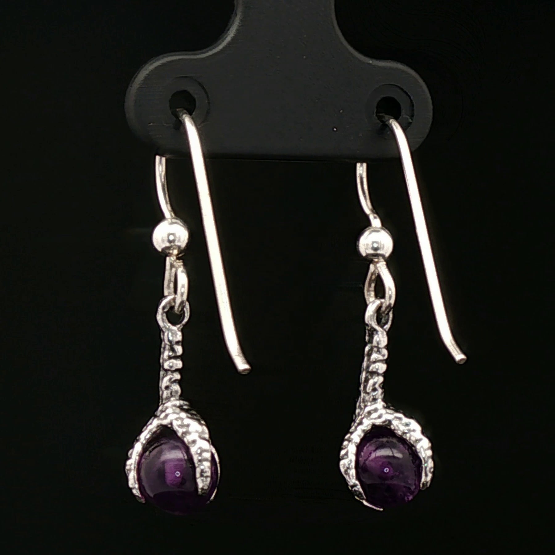 These sterling silver claw dangle earrings feature a gemstone bead and are part of the handmade fantasy jewellery collection by Le Dragon Argenté.