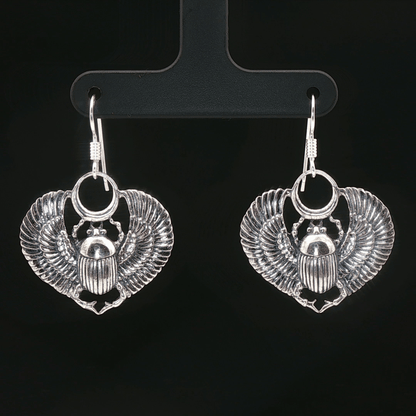 Handmade Winged scarab beetle earrings inspired by ancient Egyptian jewellery, available in sterling silver, antique bronze, or stainless steel. These symbolic scarab talisman earrings represent protection, rebirth, and transformation. A meaningful accessory for mythology lovers, museum enthusiasts, and those who enjoy unique handcrafted historical-style jewellery.