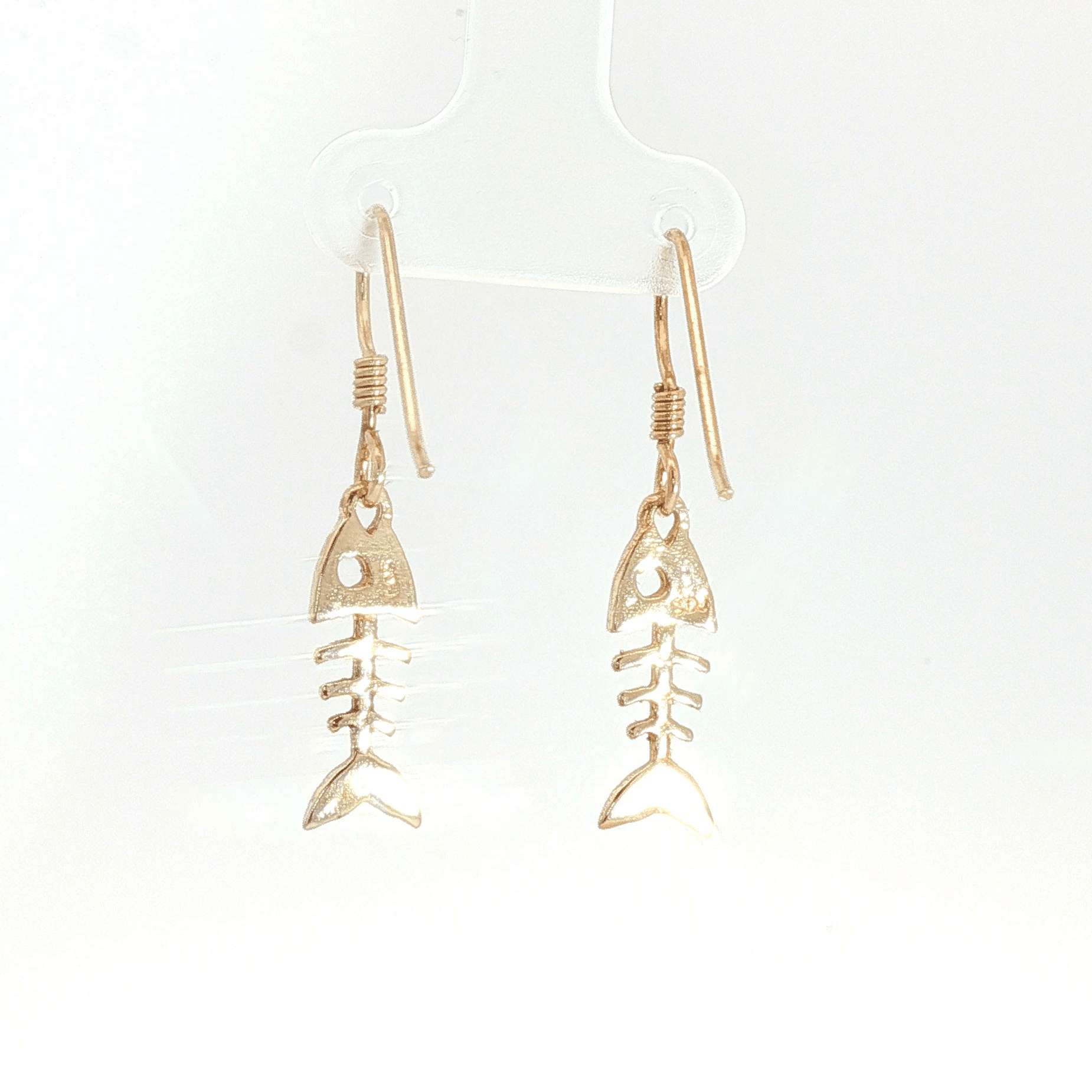 Fishbone charm earrings in antique bronze, quirky ocean jewelry, small fish skeleton dangle earrings, nautical themed animal jewelry, minimalist beach inspired earrings with playful aesthetic by Le Dragon Argenté