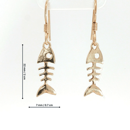 Fishbone charm earrings in antique bronze, quirky ocean jewelry, small fish skeleton dangle earrings, nautical themed animal jewelry, minimalist beach inspired earrings with playful aesthetic by Le Dragon Argenté