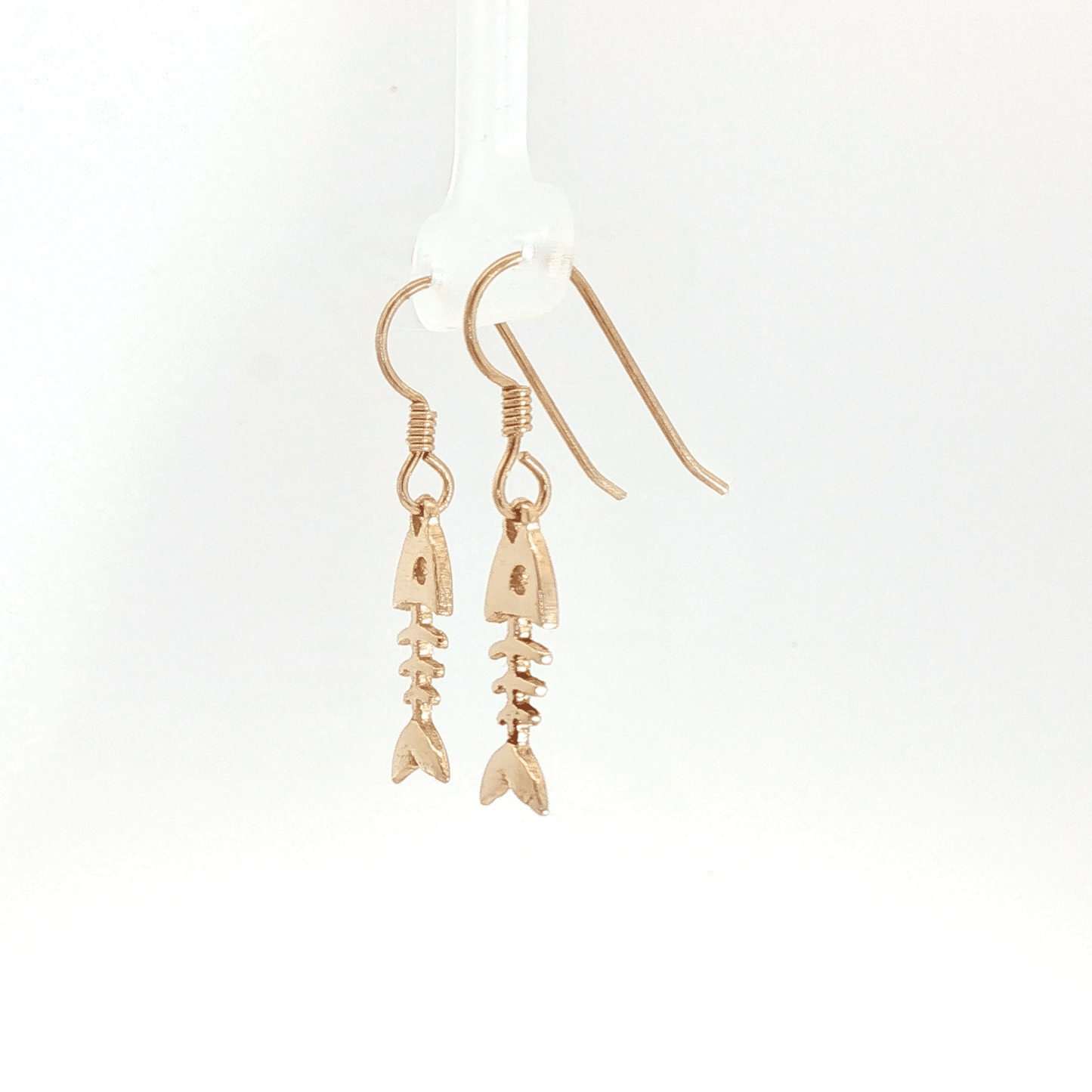 Fishbone charm earrings in antique bronze, quirky ocean jewelry, small fish skeleton dangle earrings, nautical themed animal jewelry, minimalist beach inspired earrings with playful aesthetic by Le Dragon Argenté