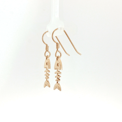 Fishbone charm earrings in antique bronze, quirky ocean jewelry, small fish skeleton dangle earrings, nautical themed animal jewelry, minimalist beach inspired earrings with playful aesthetic by Le Dragon Argenté