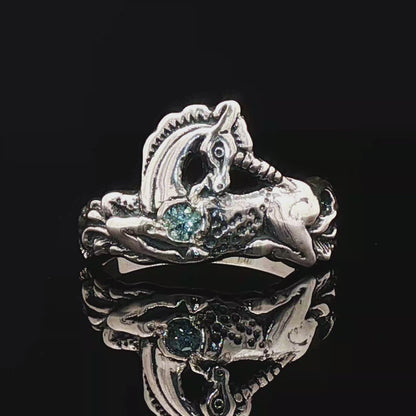 A detailed sterling silver unicorn ring with a vibrant gemstone heart, designed for lovers of unicorn jewelry and fantasy-inspired accessories by Le Dragon Argenté.