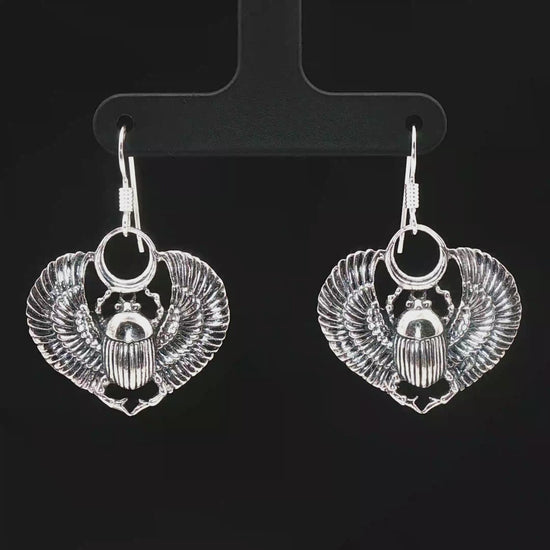 Handmade Winged scarab beetle earrings inspired by ancient Egyptian jewellery, available in sterling silver, antique bronze, or stainless steel. These symbolic scarab talisman earrings represent protection, rebirth, and transformation. A meaningful accessory for mythology lovers, museum enthusiasts, and those who enjoy unique handcrafted historical-style jewellery.