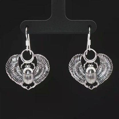 Handmade Winged scarab beetle earrings inspired by ancient Egyptian jewellery, available in sterling silver, antique bronze, or stainless steel. These symbolic scarab talisman earrings represent protection, rebirth, and transformation. A meaningful accessory for mythology lovers, museum enthusiasts, and those who enjoy unique handcrafted historical-style jewellery.