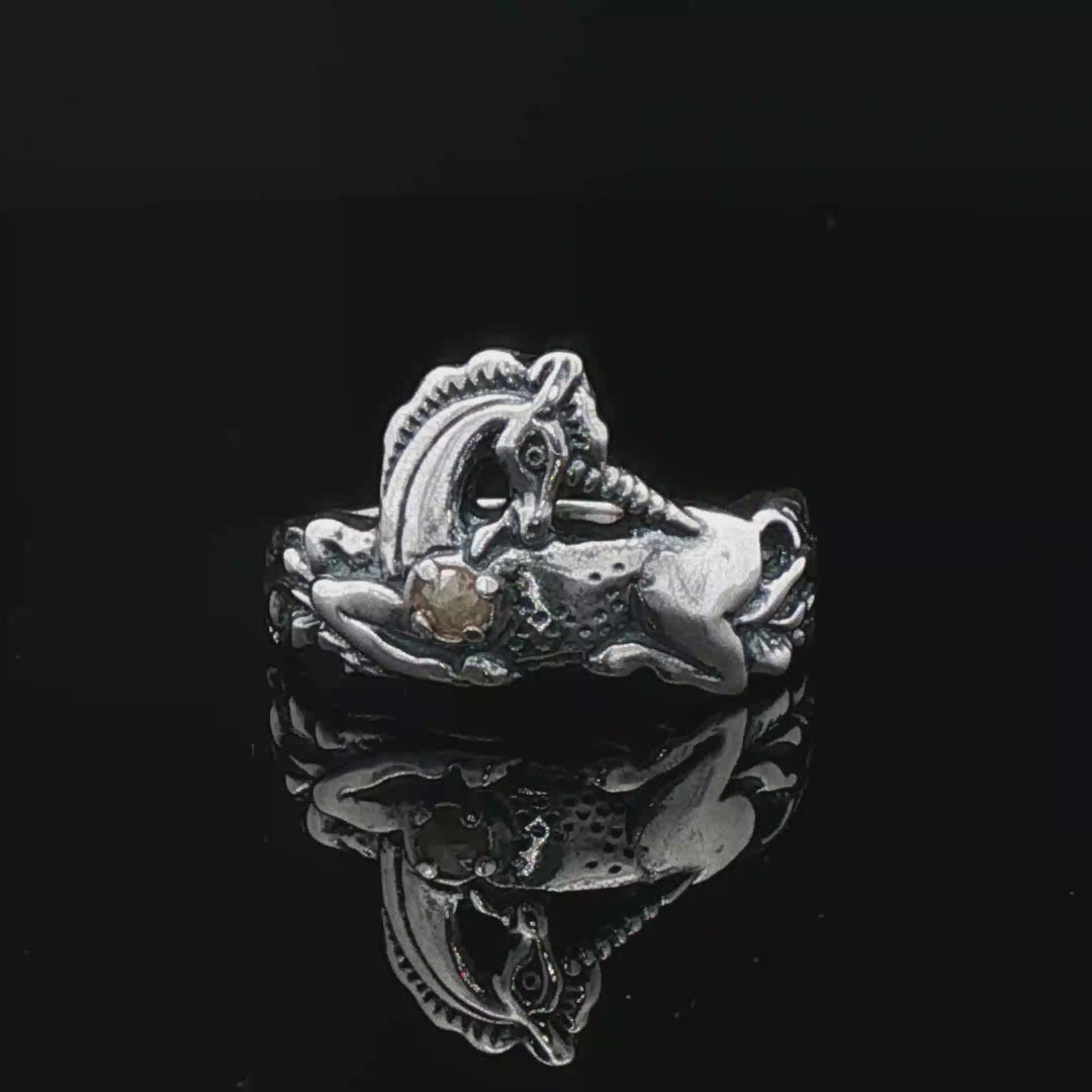A detailed sterling silver unicorn ring with a vibrant gemstone heart, designed for lovers of unicorn jewelry and fantasy-inspired accessories by Le Dragon Argenté.