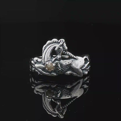 A detailed sterling silver unicorn ring with a vibrant gemstone heart, designed for lovers of unicorn jewelry and fantasy-inspired accessories by Le Dragon Argenté.