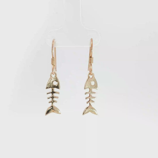 Fishbone charm earrings in antique bronze, quirky ocean jewelry, small fish skeleton dangle earrings, nautical themed animal jewelry, minimalist beach inspired earrings with playful aesthetic by Le Dragon Argenté
