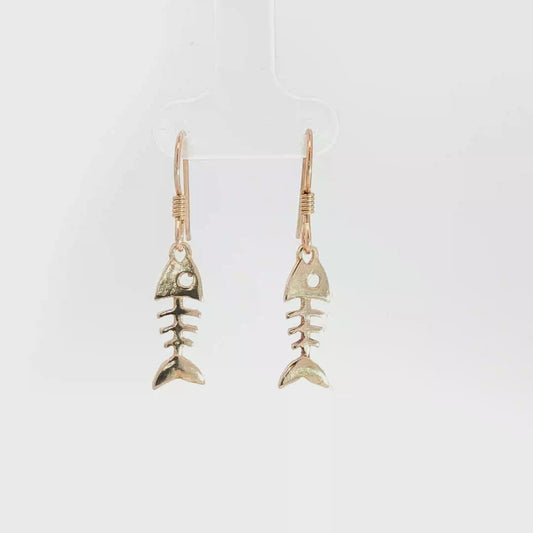 Fishbone charm earrings in antique bronze, quirky ocean jewelry, small fish skeleton dangle earrings, nautical themed animal jewelry, minimalist beach inspired earrings with playful aesthetic by Le Dragon Argenté