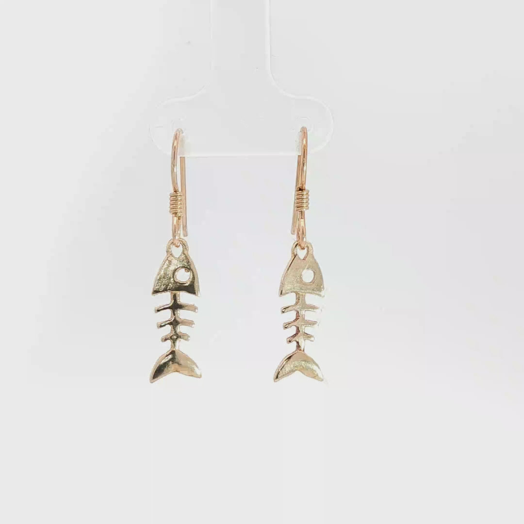 Fishbone charm earrings in antique bronze, quirky ocean jewelry, small fish skeleton dangle earrings, nautical themed animal jewelry, minimalist beach inspired earrings with playful aesthetic by Le Dragon Argenté