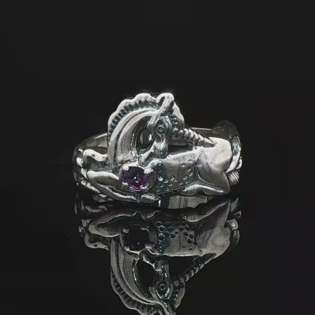 A detailed sterling silver unicorn ring with a vibrant gemstone heart, designed for lovers of unicorn jewelry and fantasy-inspired accessories by Le Dragon Argenté.