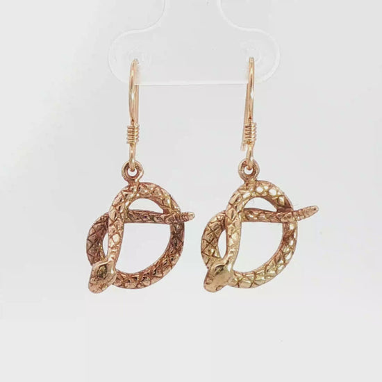 Antique bronze rattlesnake charm earrings, western gothic snake jewelry, small coiled serpent dangle earrings, desert inspired animal jewelry, edgy minimalist reptile earrings for everyday wear by Le Dragon Argenté