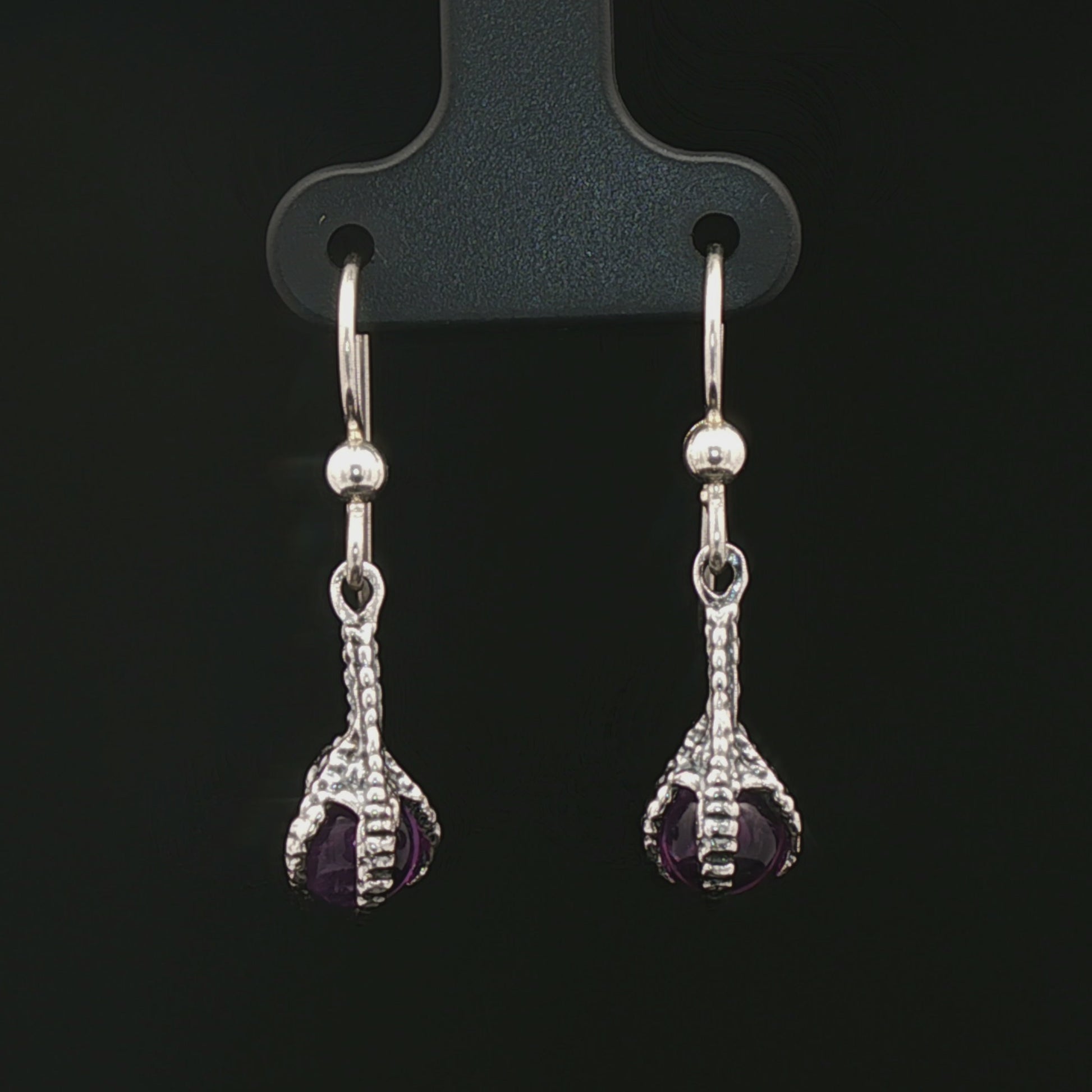 These sterling silver claw dangle earrings feature a gemstone bead and are part of the handmade fantasy jewellery collection by Le Dragon Argenté.