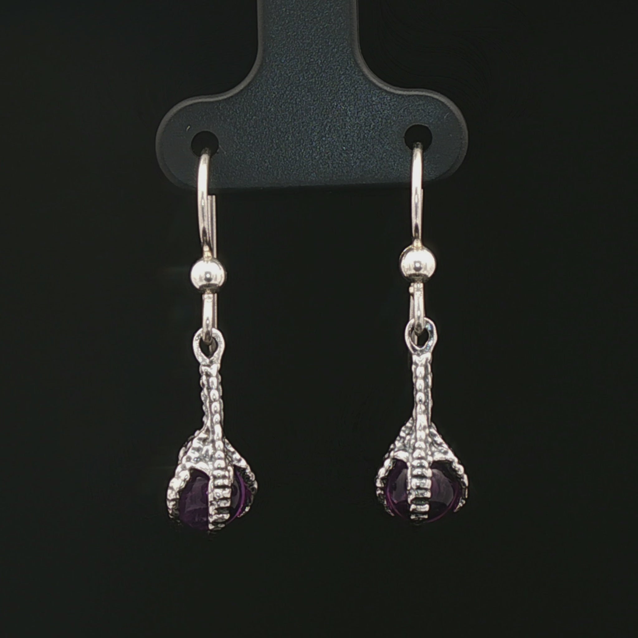 These sterling silver claw dangle earrings feature a gemstone bead and are part of the handmade fantasy jewellery collection by Le Dragon Argenté.