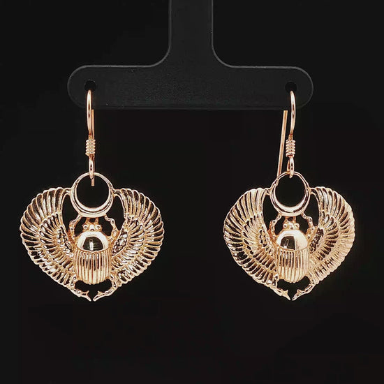 Handmade Winged scarab beetle earrings inspired by ancient Egyptian jewellery, available in sterling silver, antique bronze, or stainless steel. These symbolic scarab talisman earrings represent protection, rebirth, and transformation. A meaningful accessory for mythology lovers, museum enthusiasts, and those who enjoy unique handcrafted historical-style jewellery.