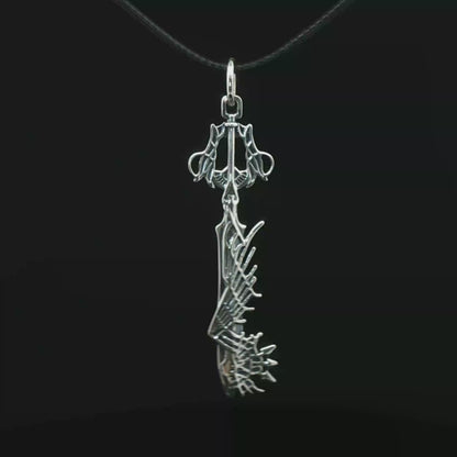 Stainless steel Ultima Keyblade pendant inspired by Kingdom Hearts, detailed gamer necklace with iconic fantasy weapon design by Le Dragon Argenté