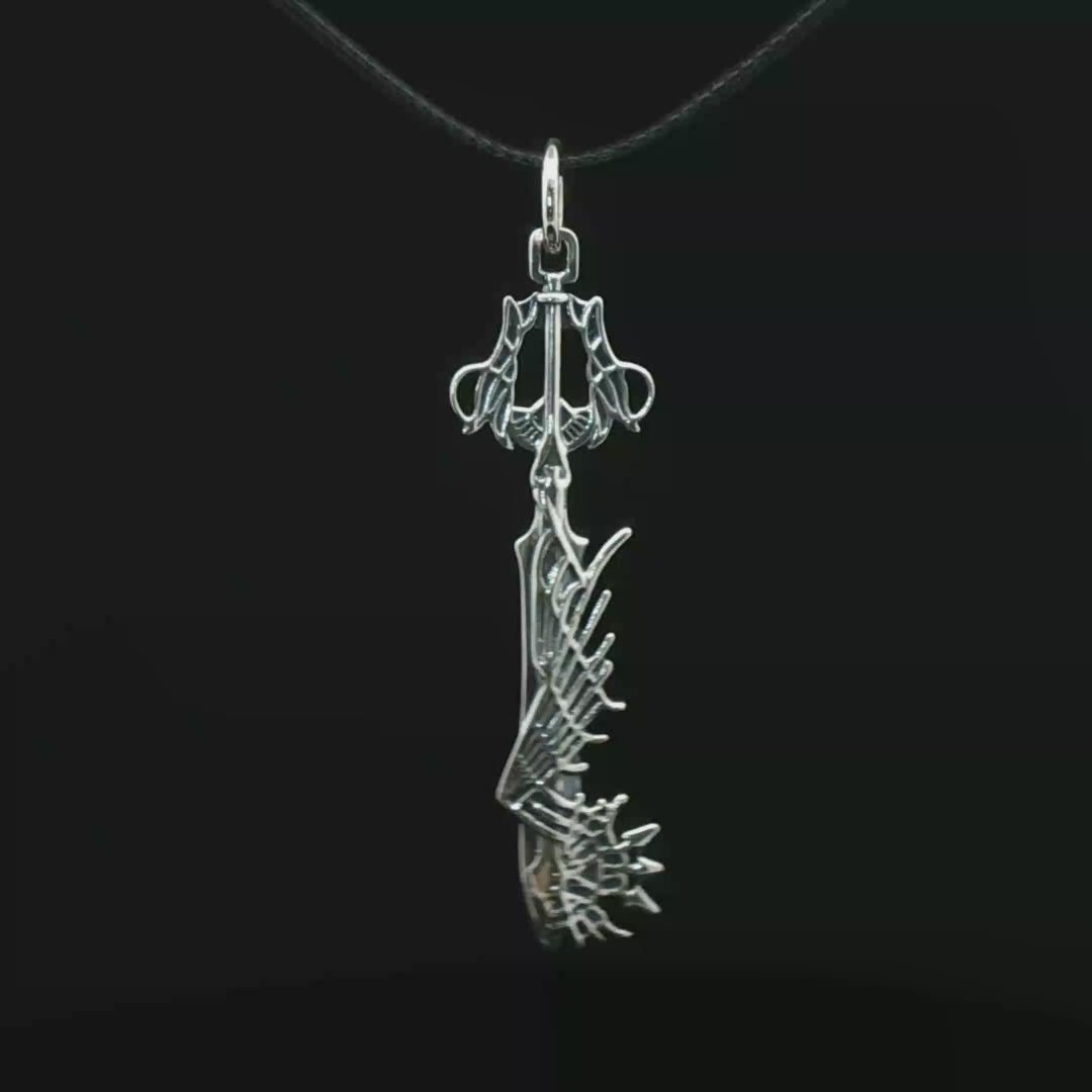 Stainless steel Ultima Keyblade pendant inspired by Kingdom Hearts, detailed gamer necklace with iconic fantasy weapon design by Le Dragon Argenté