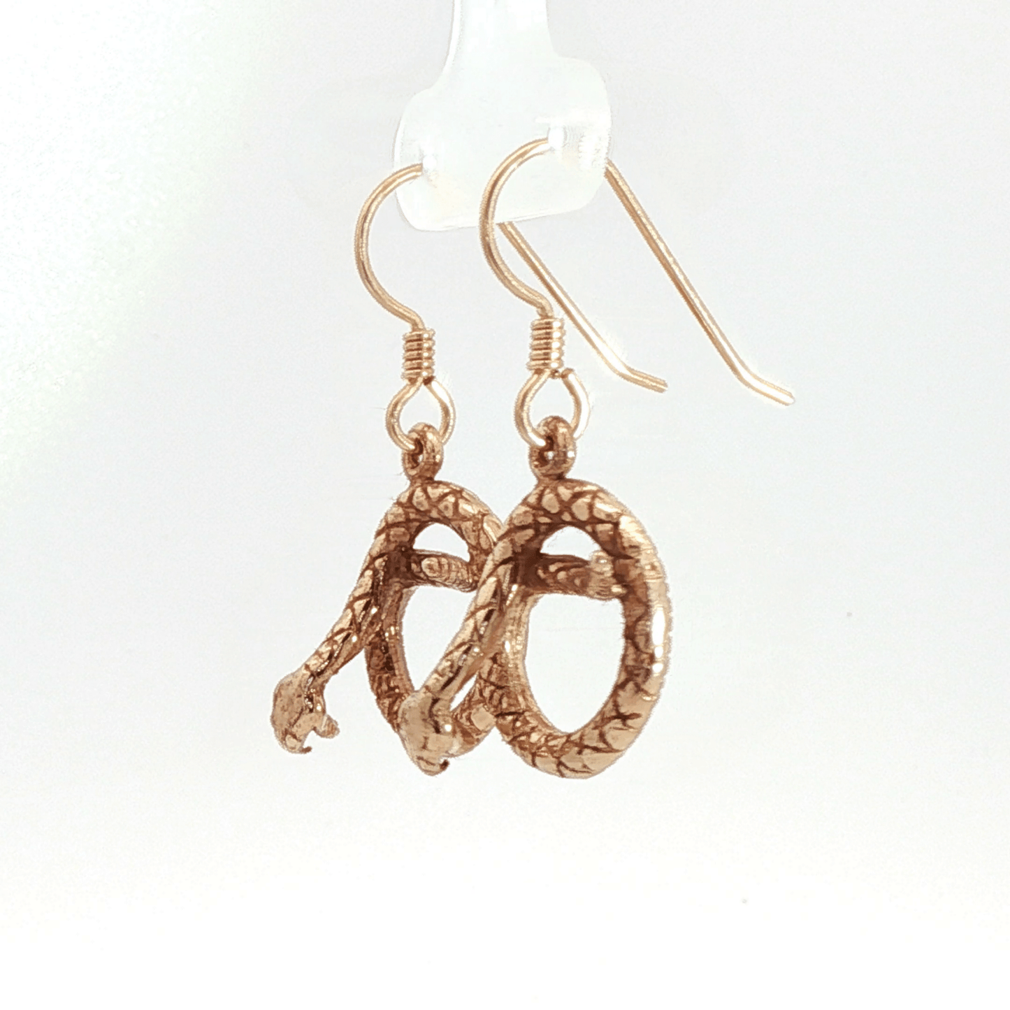 Antique bronze rattlesnake charm earrings, western gothic snake jewelry, small coiled serpent dangle earrings, desert inspired animal jewelry, edgy minimalist reptile earrings for everyday wear by Le Dragon Argenté