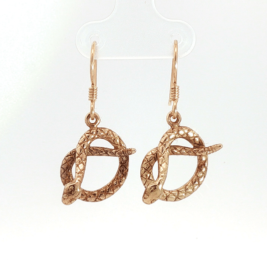 Antique bronze rattlesnake charm earrings, western gothic snake jewelry, small coiled serpent dangle earrings, desert inspired animal jewelry, edgy minimalist reptile earrings for everyday wear by Le Dragon Argenté