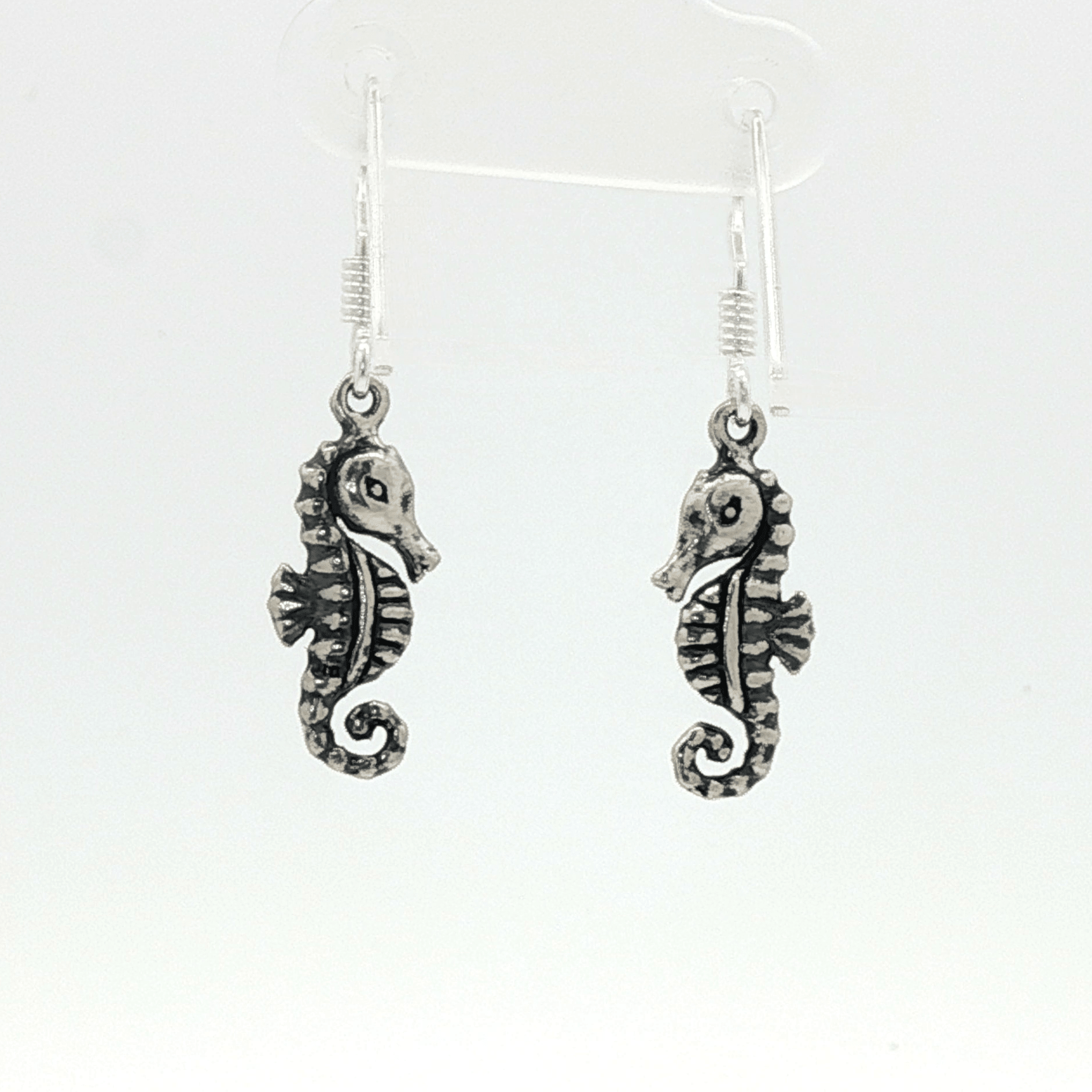 Small abstract seahorse charm earrings in sterling silver, delicate ocean inspired jewelry, minimalist sea life dangle earrings, artistic coastal style earrings, subtle nautical everyday accessory by Le Dragon Argenté