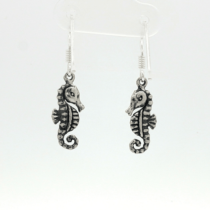 Small abstract seahorse charm earrings in sterling silver, delicate ocean inspired jewelry, minimalist sea life dangle earrings, artistic coastal style earrings, subtle nautical everyday accessory by Le Dragon Argenté