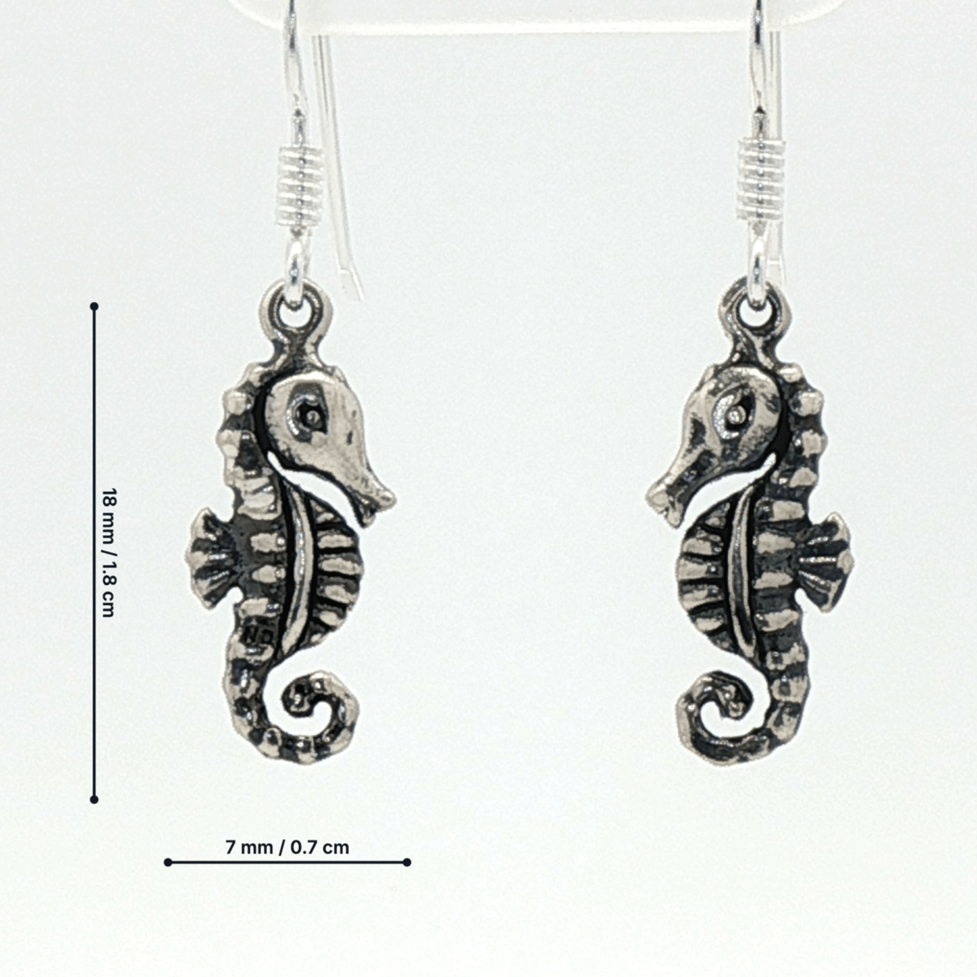 Small abstract seahorse charm earrings in sterling silver, delicate ocean inspired jewelry, minimalist sea life dangle earrings, artistic coastal style earrings, subtle nautical everyday accessory by Le Dragon Argenté