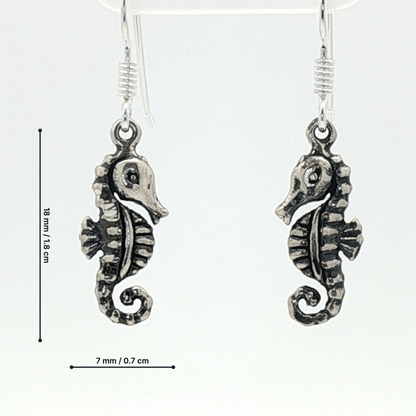 Small abstract seahorse charm earrings in sterling silver, delicate ocean inspired jewelry, minimalist sea life dangle earrings, artistic coastal style earrings, subtle nautical everyday accessory by Le Dragon Argenté