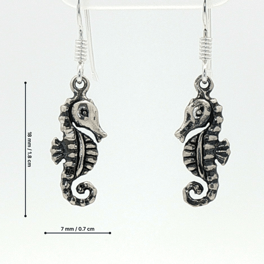 Small abstract seahorse charm earrings in sterling silver, delicate ocean inspired jewelry, minimalist sea life dangle earrings, artistic coastal style earrings, subtle nautical everyday accessory by Le Dragon Argenté