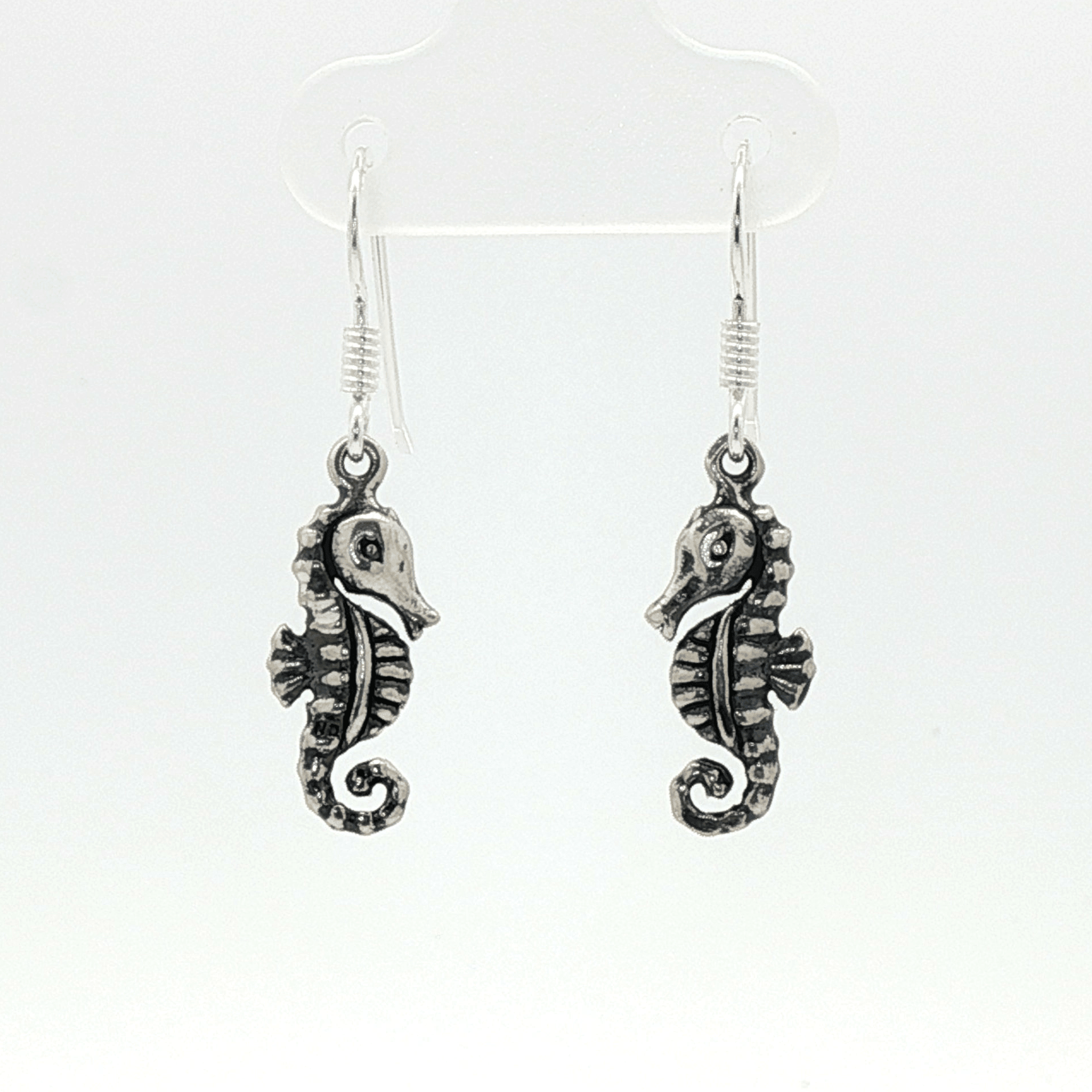 Small abstract seahorse charm earrings in sterling silver, delicate ocean inspired jewelry, minimalist sea life dangle earrings, artistic coastal style earrings, subtle nautical everyday accessory by Le Dragon Argenté