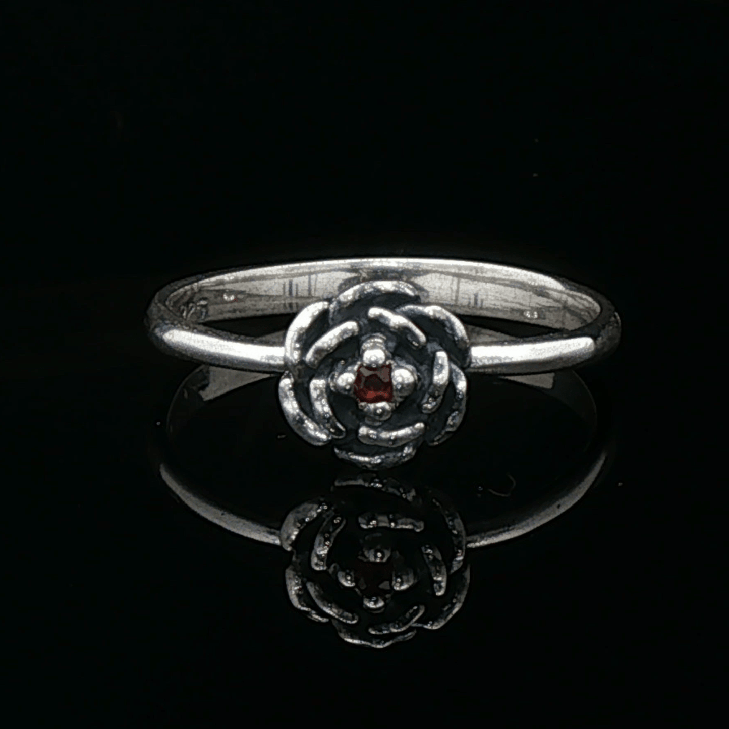 Handmade Small Rose Ring in .925 Sterling Silver featuring a delicate sculpted rose with a 1.5mm genuine gemstone at its centre. Elegant and dainty yet durable, this floral ring makes a perfect gift of love, promise, or self-expression. Crafted by Le Dragon Argenté in Montreal, Canada.