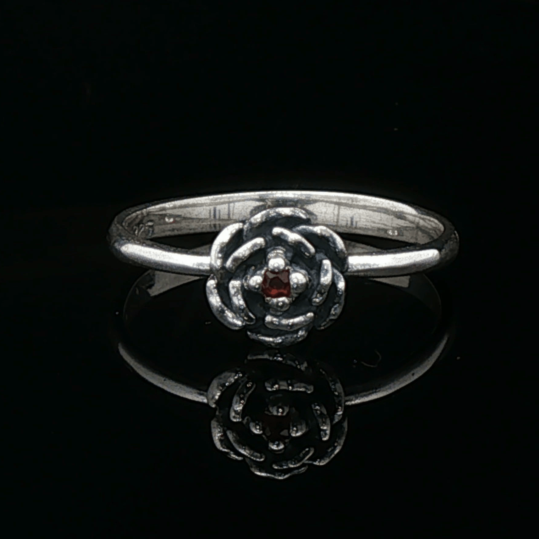 Handmade Small Rose Ring in .925 Sterling Silver featuring a delicate sculpted rose with a 1.5mm genuine gemstone at its centre. Elegant and dainty yet durable, this floral ring makes a perfect gift of love, promise, or self-expression. Crafted by Le Dragon Argenté in Montreal, Canada.