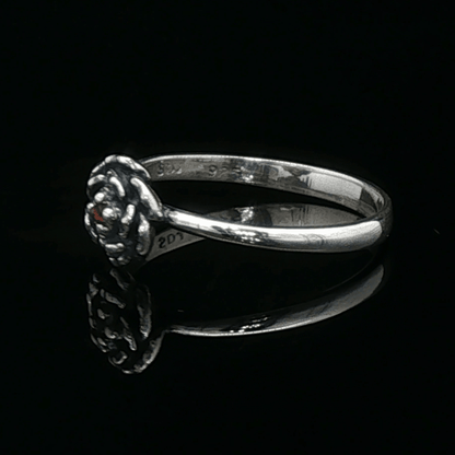 Handmade Small Rose Ring in .925 Sterling Silver featuring a delicate sculpted rose with a 1.5mm genuine gemstone at its centre. Elegant and dainty yet durable, this floral ring makes a perfect gift of love, promise, or self-expression. Crafted by Le Dragon Argenté in Montreal, Canada.