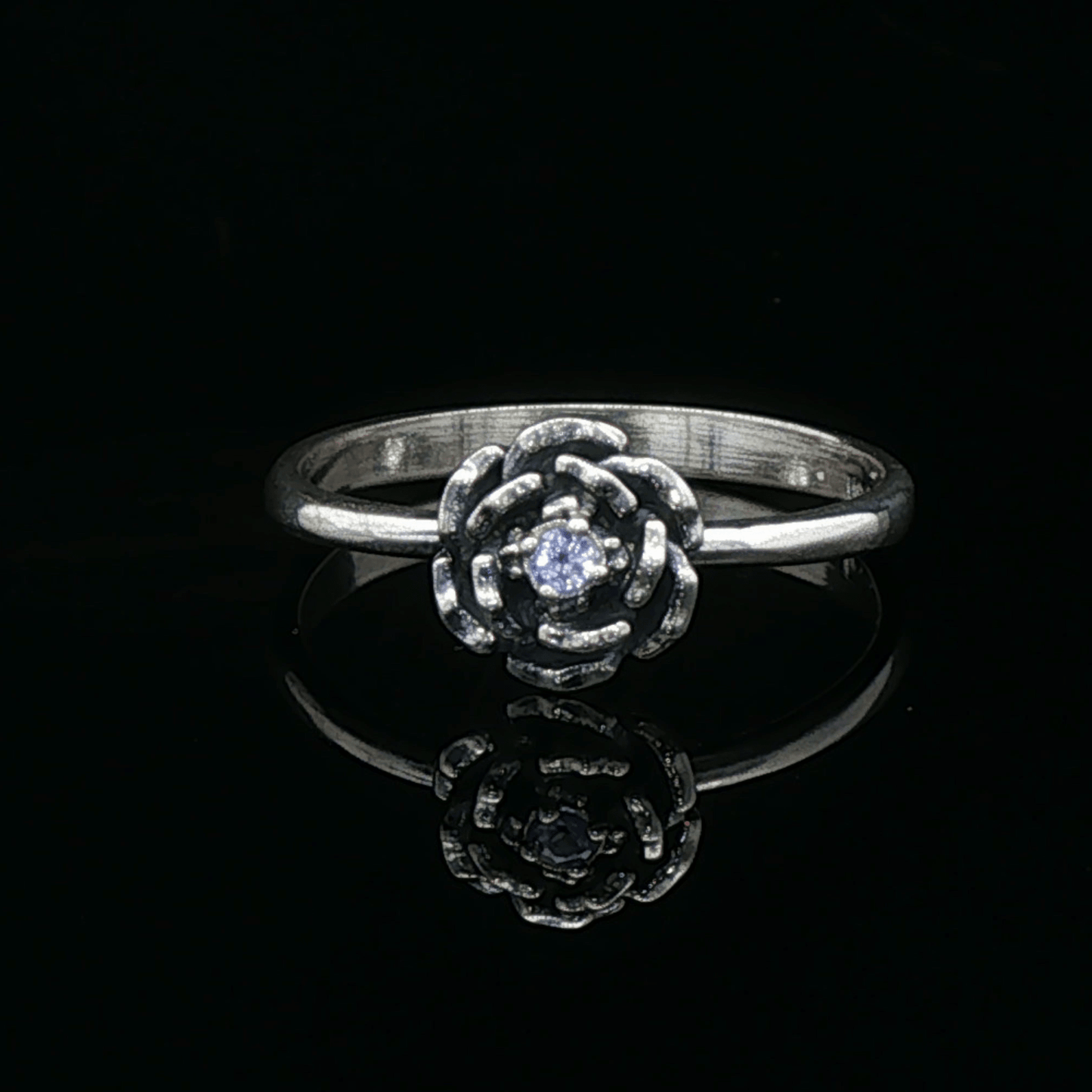 Handmade Small Rose Ring in .925 Sterling Silver featuring a delicate sculpted rose with a 1.5mm genuine gemstone at its centre. Elegant and dainty yet durable, this floral ring makes a perfect gift of love, promise, or self-expression. Crafted by Le Dragon Argenté in Montreal, Canada.