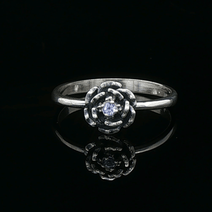 Handmade Small Rose Ring in .925 Sterling Silver featuring a delicate sculpted rose with a 1.5mm genuine gemstone at its centre. Elegant and dainty yet durable, this floral ring makes a perfect gift of love, promise, or self-expression. Crafted by Le Dragon Argenté in Montreal, Canada.
