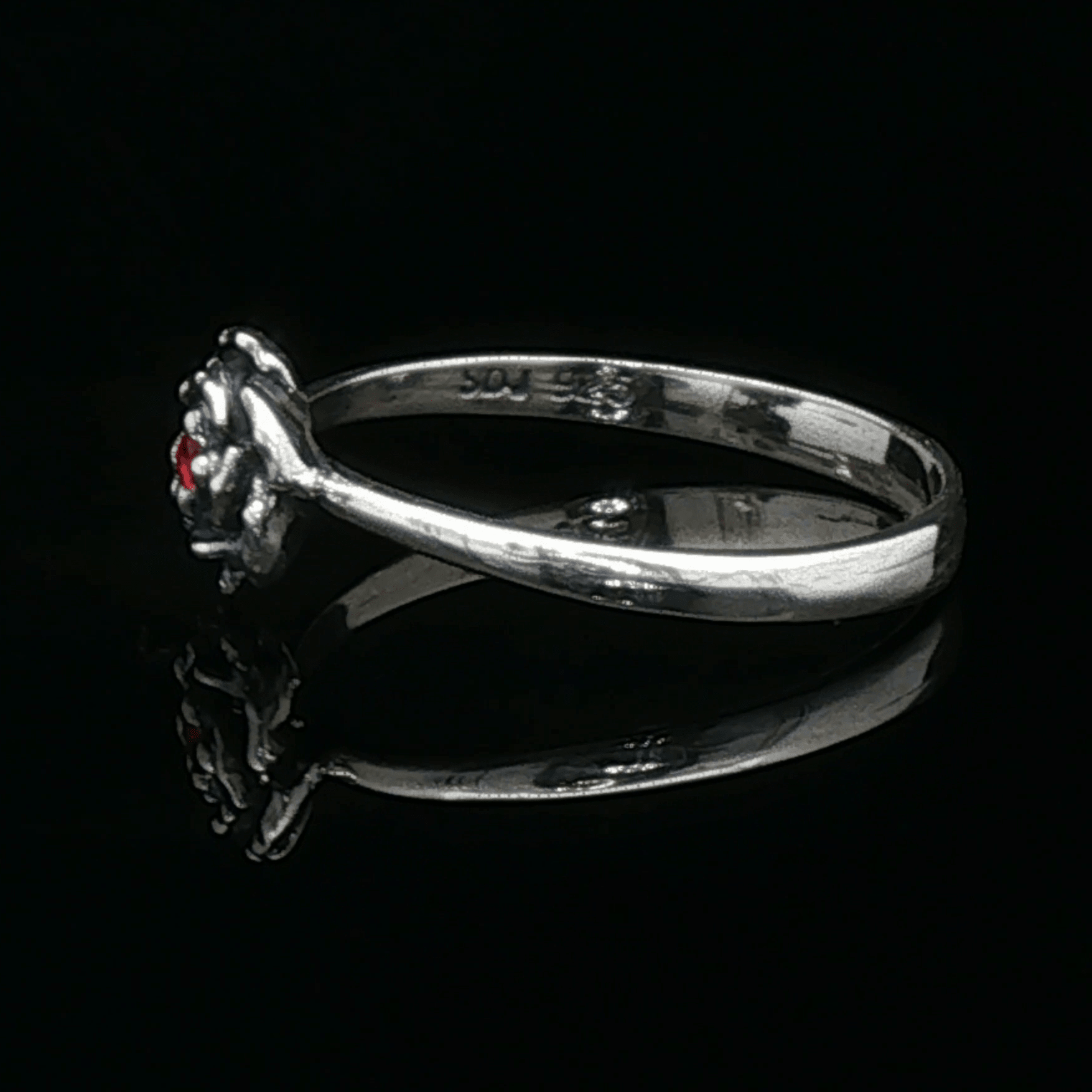 Handmade Small Rose Ring in .925 Sterling Silver featuring a delicate sculpted rose with a 1.5mm coloured cubic zirconia birthstone at its centre. Elegant and dainty yet durable, this floral ring makes a perfect gift of love, promise, or self-expression. Crafted by Le Dragon Argenté in Montreal, Canada.