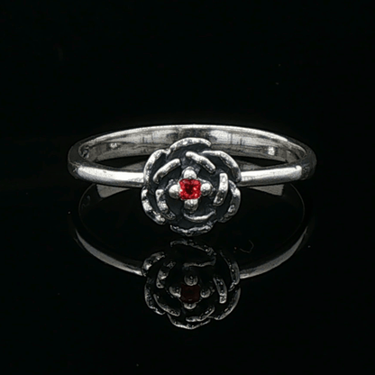 Handmade Small Rose Ring in .925 Sterling Silver featuring a delicate sculpted rose with a 1.5mm coloured cubic zirconia birthstone at its centre. Elegant and dainty yet durable, this floral ring makes a perfect gift of love, promise, or self-expression. Crafted by Le Dragon Argenté in Montreal, Canada.