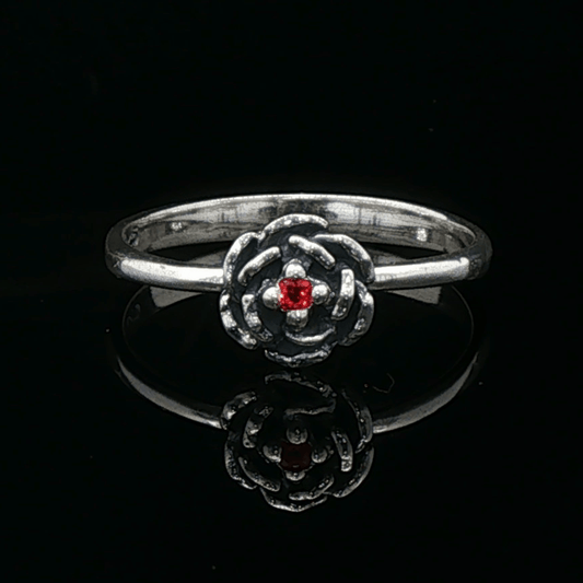 Handmade Small Rose Ring in .925 Sterling Silver featuring a delicate sculpted rose with a 1.5mm coloured cubic zirconia birthstone at its centre. Elegant and dainty yet durable, this floral ring makes a perfect gift of love, promise, or self-expression. Crafted by Le Dragon Argenté in Montreal, Canada.