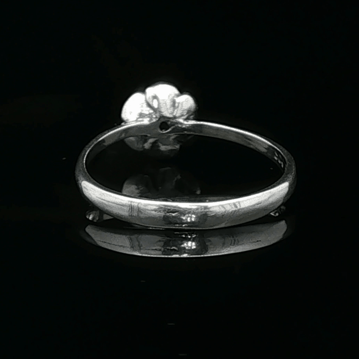 Handmade Small Rose Ring in .925 Sterling Silver featuring a delicate sculpted rose with a 1.5mm coloured cubic zirconia birthstone at its centre. Elegant and dainty yet durable, this floral ring makes a perfect gift of love, promise, or self-expression. Crafted by Le Dragon Argenté in Montreal, Canada.