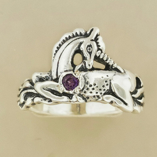 A detailed sterling silver unicorn ring with a vibrant gemstone heart, designed for lovers of unicorn jewelry and fantasy-inspired accessories by Le Dragon Argenté.