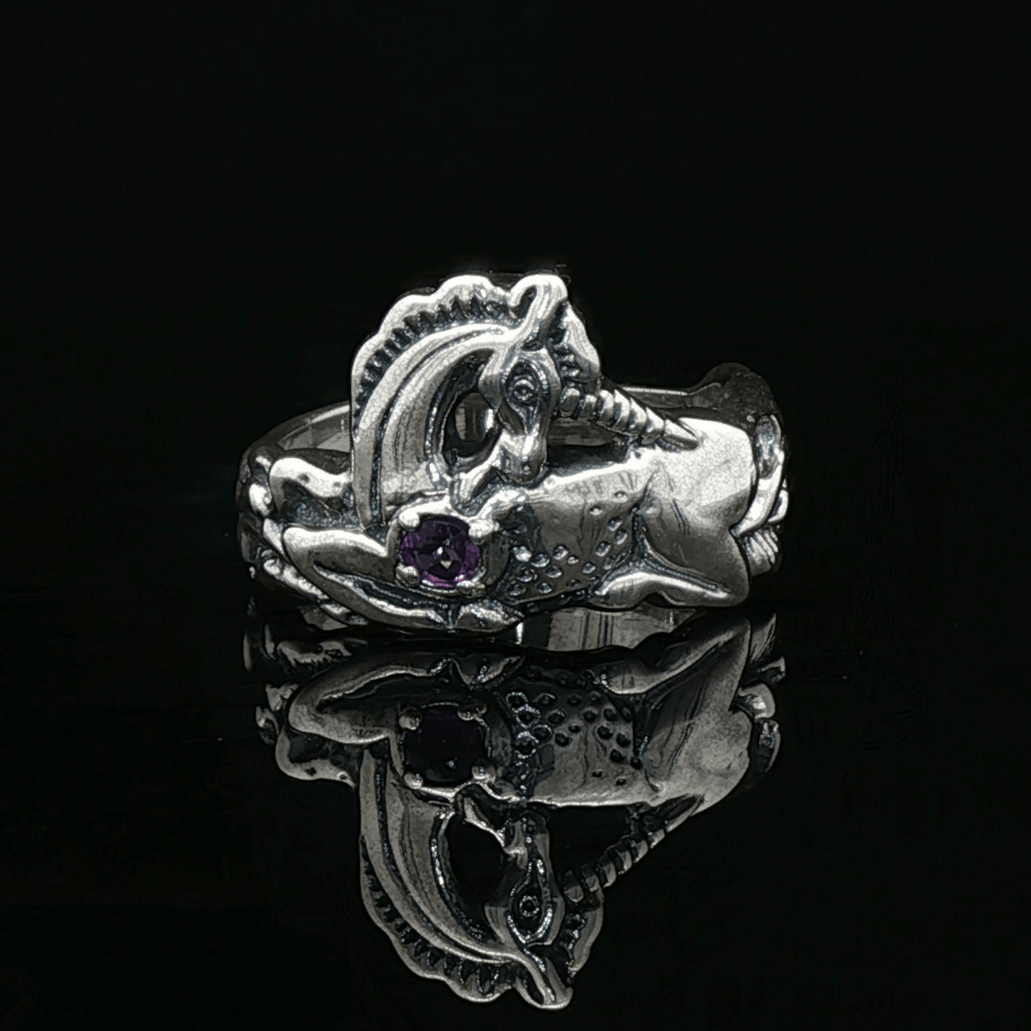 A detailed sterling silver unicorn ring with a vibrant gemstone heart, designed for lovers of unicorn jewelry and fantasy-inspired accessories by Le Dragon Argenté.